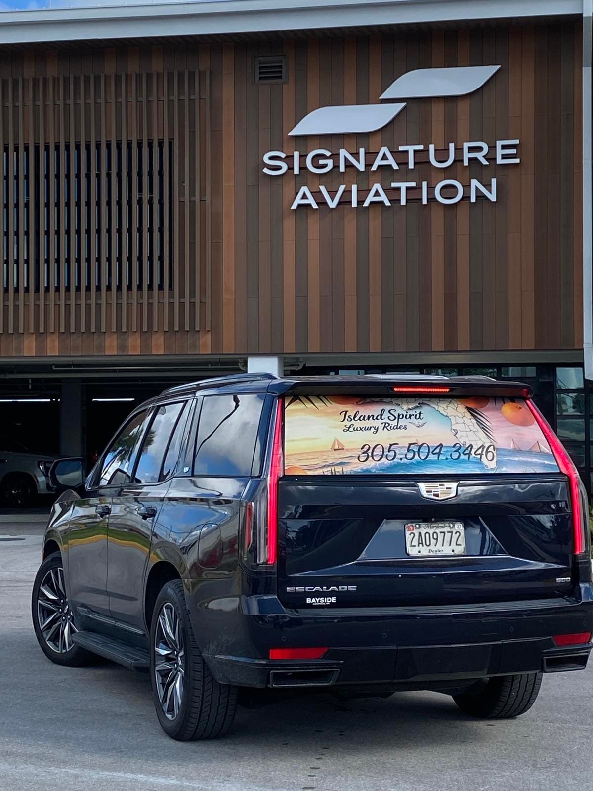 Three-quarter rear view of the Island Spirit Cadillac Escalade outdoors