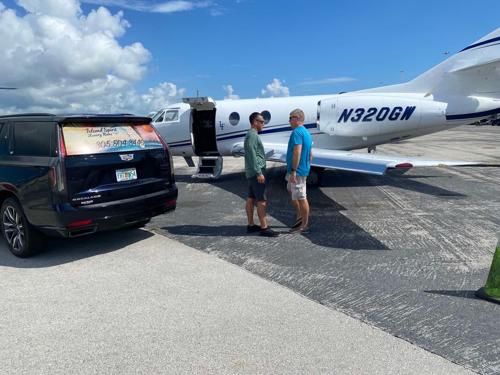 Island Spirit Cadillac Escalade beside a private aircraft in Key West